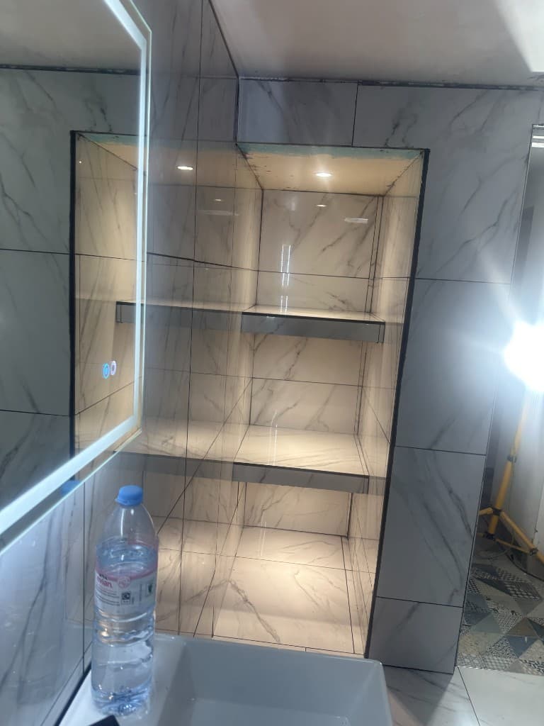 Recessed tiled bathroom niche with integrated lighting