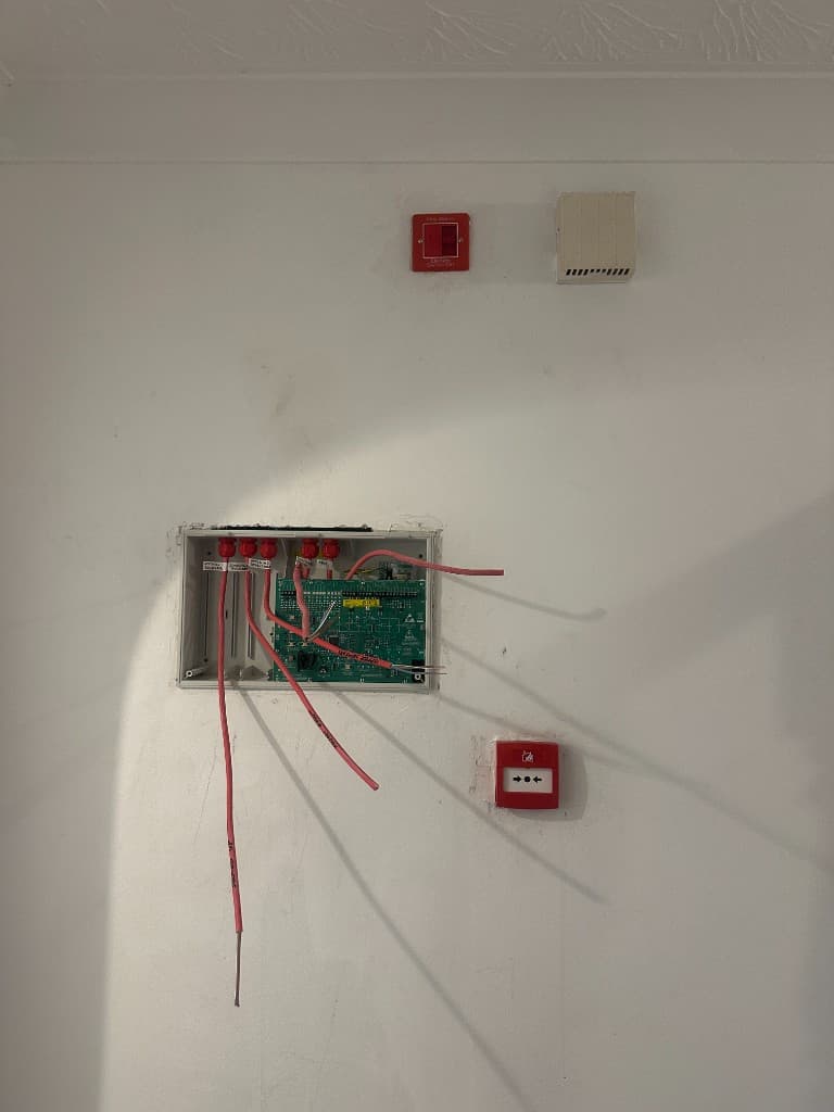 Fire-alarm control equipment and call points being installed