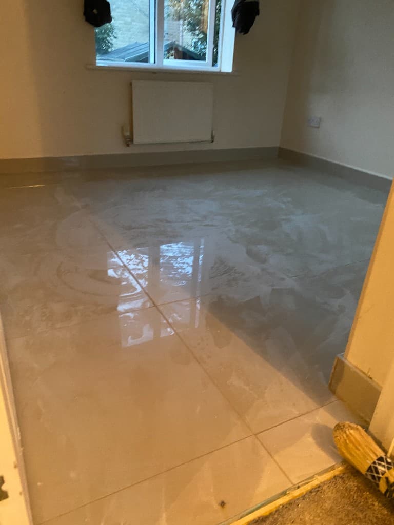 Large-format floor tiles after installation, with a high-gloss finish