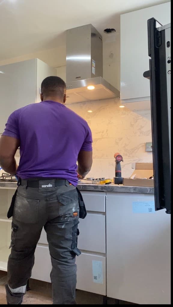 Kitchen being fitted, with splashback tiling and units in progress