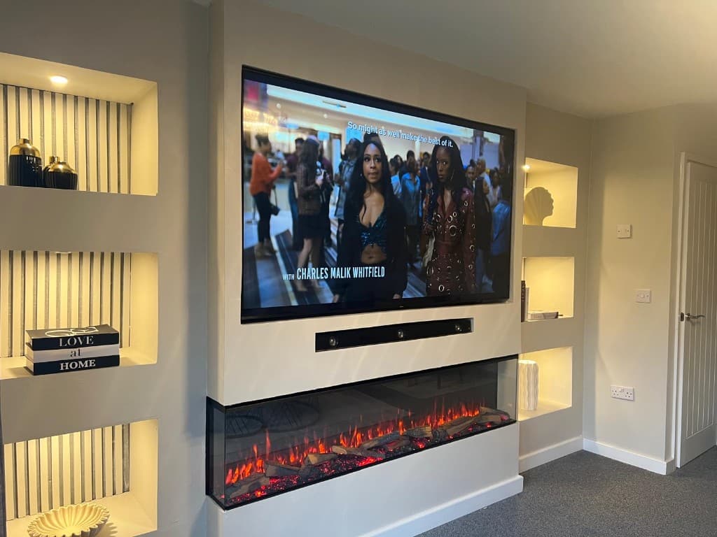Media wall with a television, electric fire and built-in shelves with LED lighting