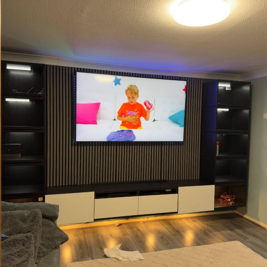 Media wall with a wall-mounted television, slatted timber panel, side storage and LED lighting