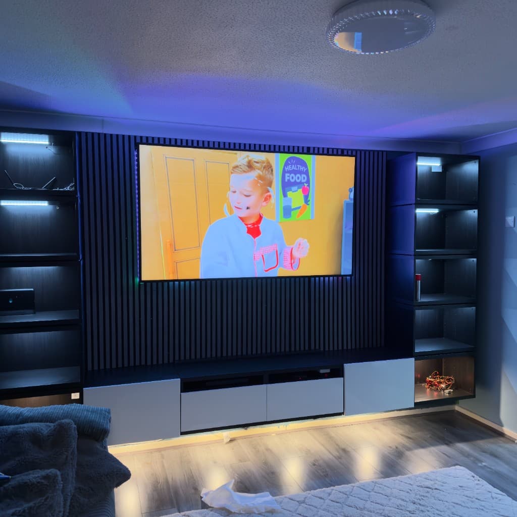 Media wall with slatted feature panelling, illuminated shelves and a wall-mounted television