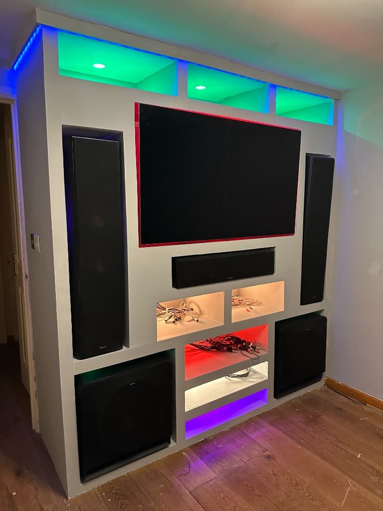 Bespoke media wall with a television, speakers and colour-changing LED display niches